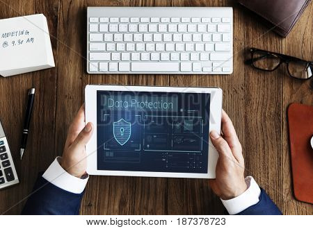 Hands working on digital device network graphic overlay