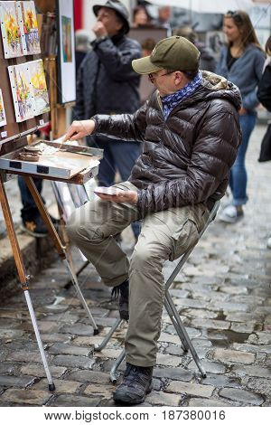 Paris, France - May 12, 2017: An artist painting on Place du Tertre in Montmartre district in Paris