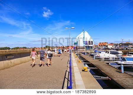 HEL POLAND - AUGUST 10 2015: People walking through in the port on the waterfront with many boat and sailboat in Hel. Hel is one of most famous cruise travel destinations in Poland.