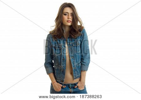 charming young girl with beautiful hair posing for the camera in a jeans jacket isolated on white background