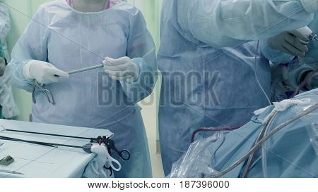 Laparoscopic surgery of the abdomen. The surgical nurse prepares the medical instrument