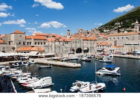 DUBROVNIK CROATIA - JULY 16 2016: arriving recreational boat for tourists at the Old Port in a sunny summer day. Adriatic blue waters and beautiful islands are an attraction in the Croatian coast.