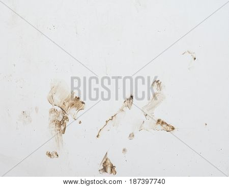White wall with the splasing mud near the construction site.