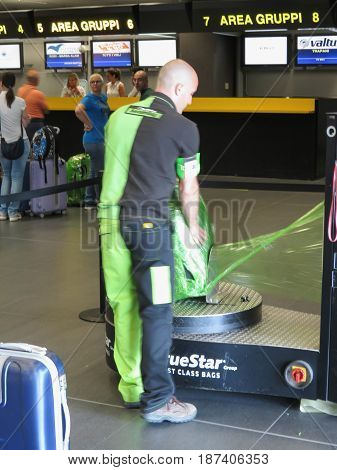 Luggage Wrapping With Plastic Sheet