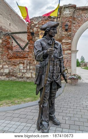 ALBA IULIA Romania - APRIL 29 2017: Bronze statue with soldier in front of one Gate of the City in Citadel of Alba Iulia city.