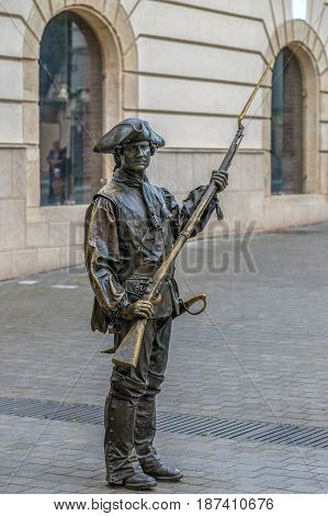 ALBA IULIA Romania - APRIL 30 2017: Bronze statue with soldier in front of Third Gate of the City in Citadel of Alba Iulia city.