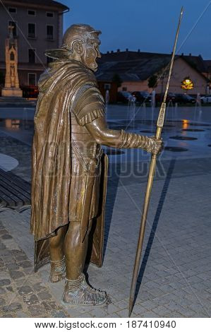 ALBA IULIA ROMANIA - APRIL 30 2017: Bronze statue depicting a Roman legionary holding his spear and shield standing guard at the entrance of the Principia relics Museum in Alba Iulia Citadel square