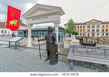 ALBA IULIA ROMANIA - APRIL 30 2017: Bronze statue depicting a Roman legionary holding his spear and shield standing guard at the entrance of the Principia relics Museum in Alba Iulia Citadel square