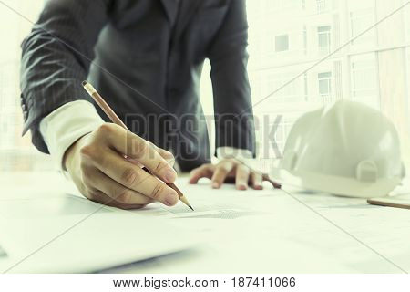engineer drawing architecture project on blueprint in office engineering concept architecture concept soft focus vintage tone