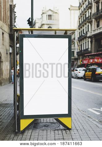 Blank advertising light box on bus stop mockup of empty ad billboard on night bus station template banner on background city street for message or text in Barcelona afisha board and headlights of taxi cars