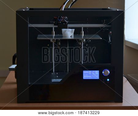 Objects printed by 3d printer. Automatic three dimensional 3d printer performs plastic modeling in laboratory. Progressive modern additive technology