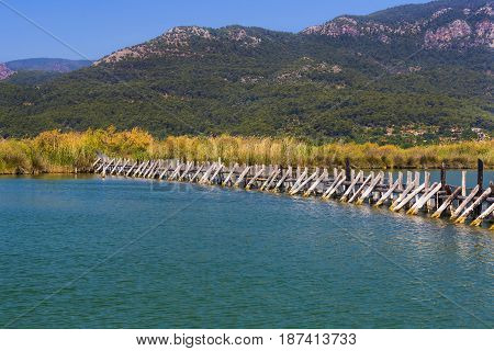 TURKEY, MUGLA ,DALYAN, - 5 MAY , 2017: The Dalyan River with tourist boats in the straits of the river