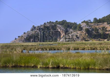 TURKEY, MUGLA ,DALYAN, - 5 MAY , 2017: The Dalyan River with tourist boats in the straits of the river