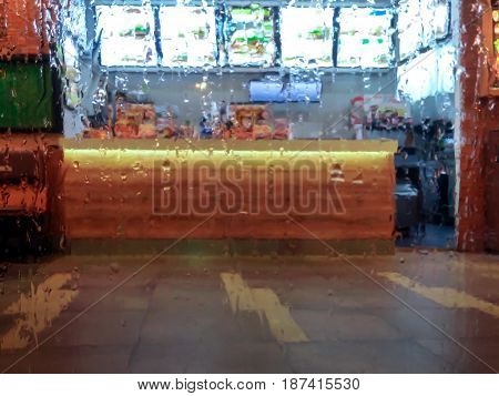 Fast Food Counter on a Rainy Day through Wet Window Glass