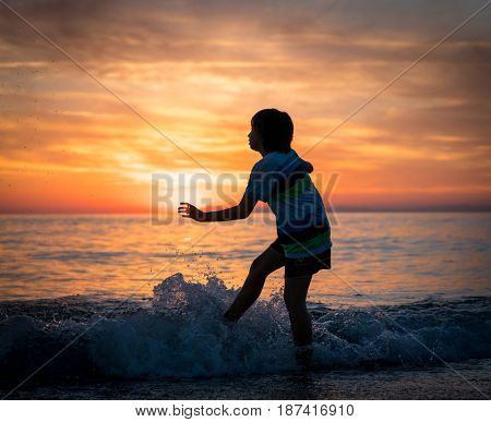 Happy boy enjoying the beach