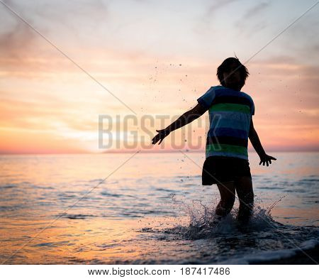 Happy boy enjoying the beach