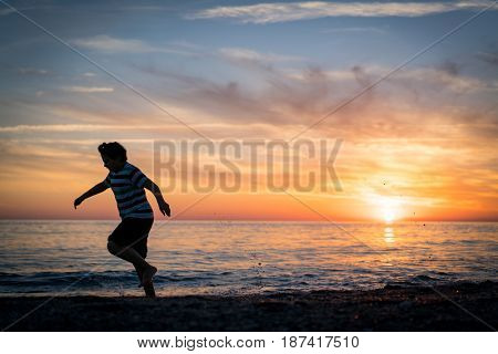 Happy boy enjoying the beach
