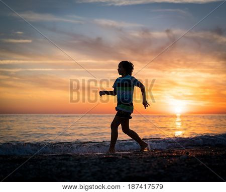 Happy boy enjoying the beach