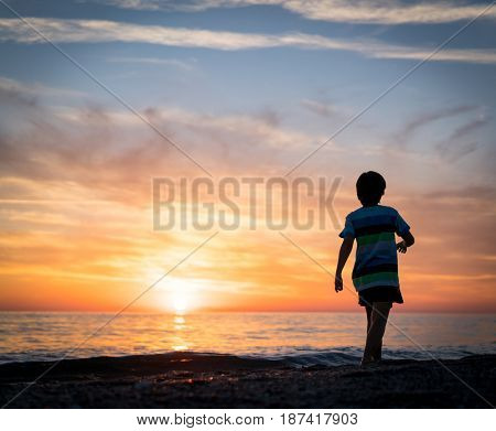 Happy boy enjoying the beach
