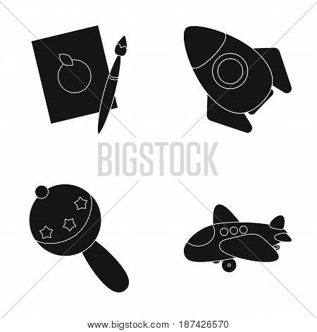 A sheet of paper with an apple pattern, a paint brush, a flying rocket with a porthole, a rattle for a child, an airplane with a chassis and a porthole. Toys set collection icons in black style vector symbol stock illustration