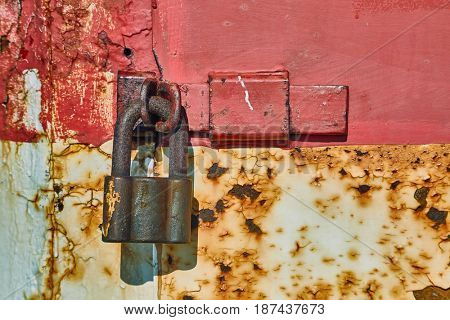 Padlock on an old metal door