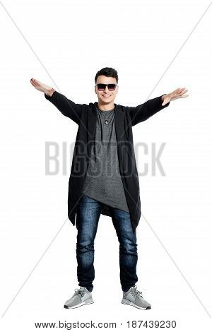 Casual young man wearing sunglasses, hands up, bent backwords, happy, positive attitude, full lenght, isolated on white