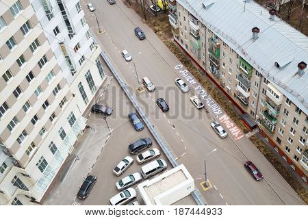 MOSCOW - APR 14, 2016: (top view) Cars near buildings in Elk island residential complex, text translation - happy birthday to Masik, Elk island was built by Donstroy Company, established in 1994