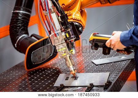 Fibre laser robotic remote cutting system. CNC Laser plasma cutting of metal, modern industrial technology.
