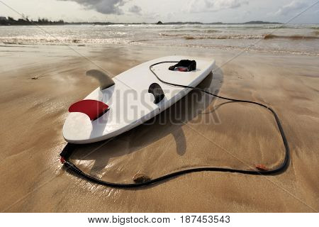 closeup of one Surfboard at beach ready for surfing