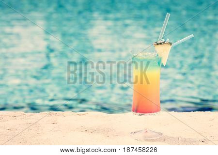 Rainbow Cocktail At The Edge Of A Resort Pool.  Concept Of Luxury Vacation