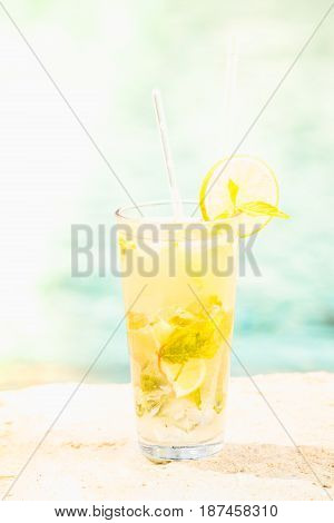 Mojito Cocktail At The Edge Of A Resort Pool.  Concept Of Luxury Vacation