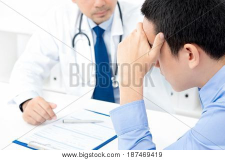 Young stressed male patient consulting with doctor