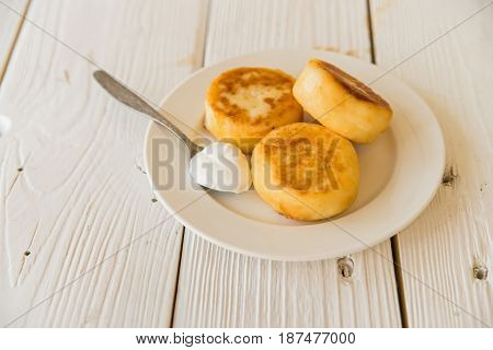 Close up freshly cooked Syrniki or cheesecakes for breakfast on plate