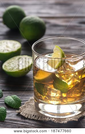 Glass of rum on the wooden background
