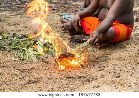 DABANA, SRI LANKA - CIRCA DECEMBER 2016: Vedda men making fire. Veddas are an indigenous people of Sri Lanka living in tribes in the jungle