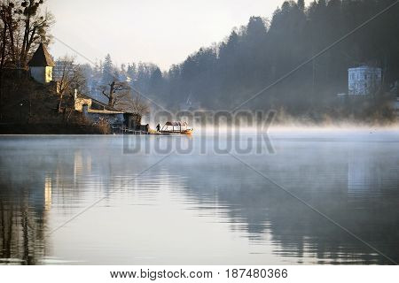 A Pletna boat near the Assumption church in the lake of Bled Slovenia.