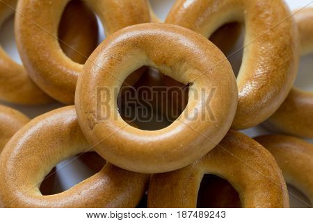 Heap of baked dry bagels close-up, top view