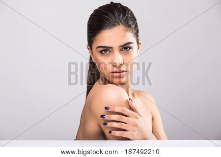 Beautiful Young Woman With Clean Fresh Skin Touch Own Face . Facial Treatment . Cosmetology , Beauty