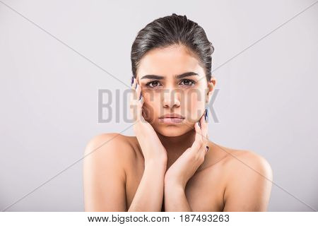 Beautiful Young Woman With Clean Fresh Skin Touch Own Face . Facial Treatment . Cosmetology , Beauty