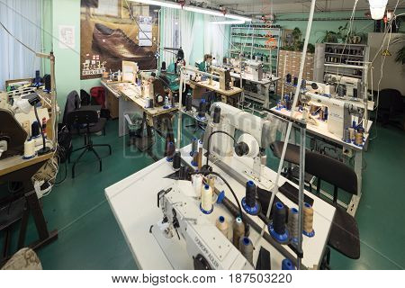 MOSCOW, RUSSIA - FEBRUARY 21, 2017: Moscow shoe factory JSC RALF RINGER . Female and male workers on a sewing machine.