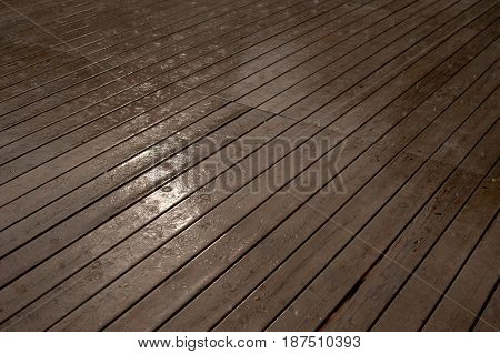 Texture of a wooden wet floor in the rain