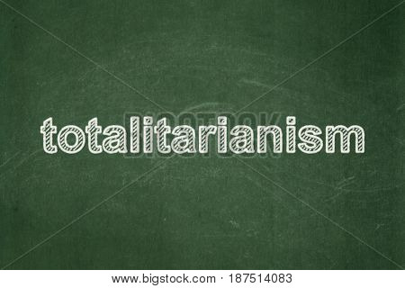 Politics concept: text Totalitarianism on Green chalkboard background