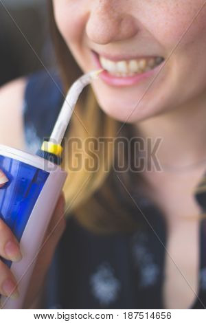A woman using an oral irrigator in bathroom. Selective focus.