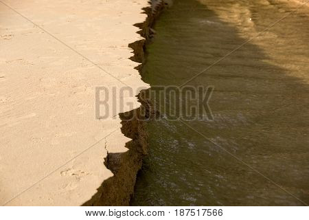 Close up Sandbank was eroded with water.
