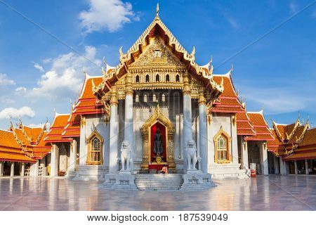 BANGKOK THAILAND - SEPTEMBER 10: Woman with her son prays at the Marble Temple on Septemper 10 2016 in Bangkok Thailand.