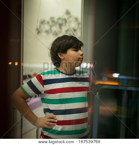 appy boy looking from apartment window
