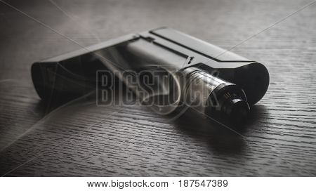 Black Vaporizer On The Brown Wooden Table