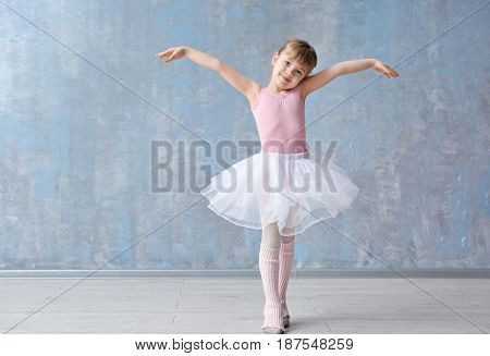 Cute little ballerina in dance studio
