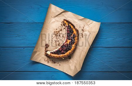Top View Of Cheesecake On The Kraft Paper On The Blue Boards