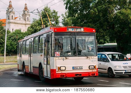 Vilnius, Lithuania  - July 5, 2016:  Old Public Trolleybus Skoda 14Tr In Summer Street And Church Of The St Raphael The Archangel On Background
